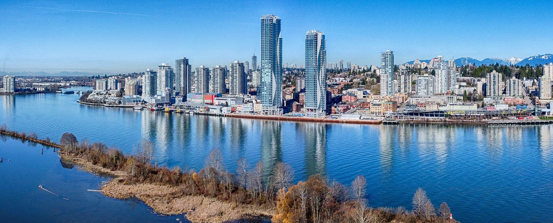 New Westminster waterfront and skyline seen across the Fraser River in March 2024